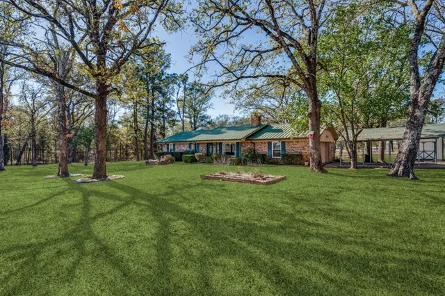 a view of an house with backyard space and balcony