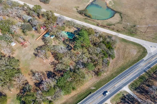 a view of a yard with a wooden fence