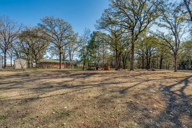 front view of a brick house with a yard
