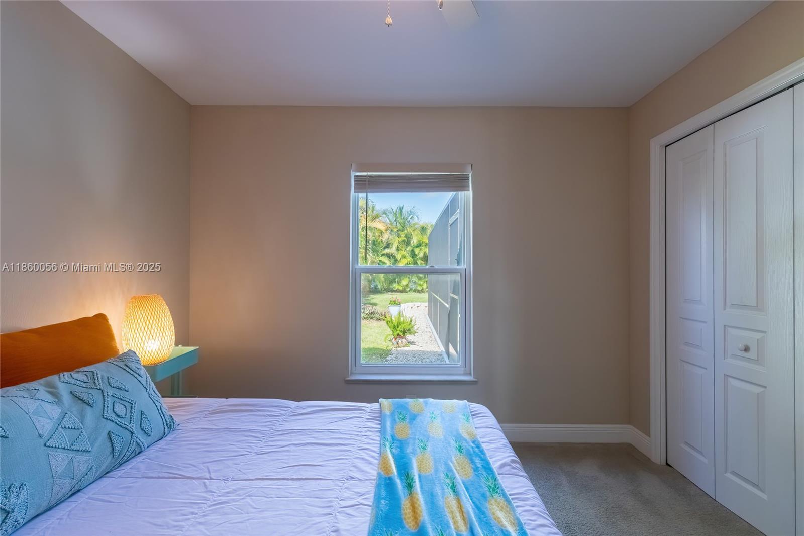 36 Lakeside Trail Lake Placid, FL 33852 - Photo 34 of 48 Guest bedroom with a beautiful and private view of the pool area with lush landscaping.