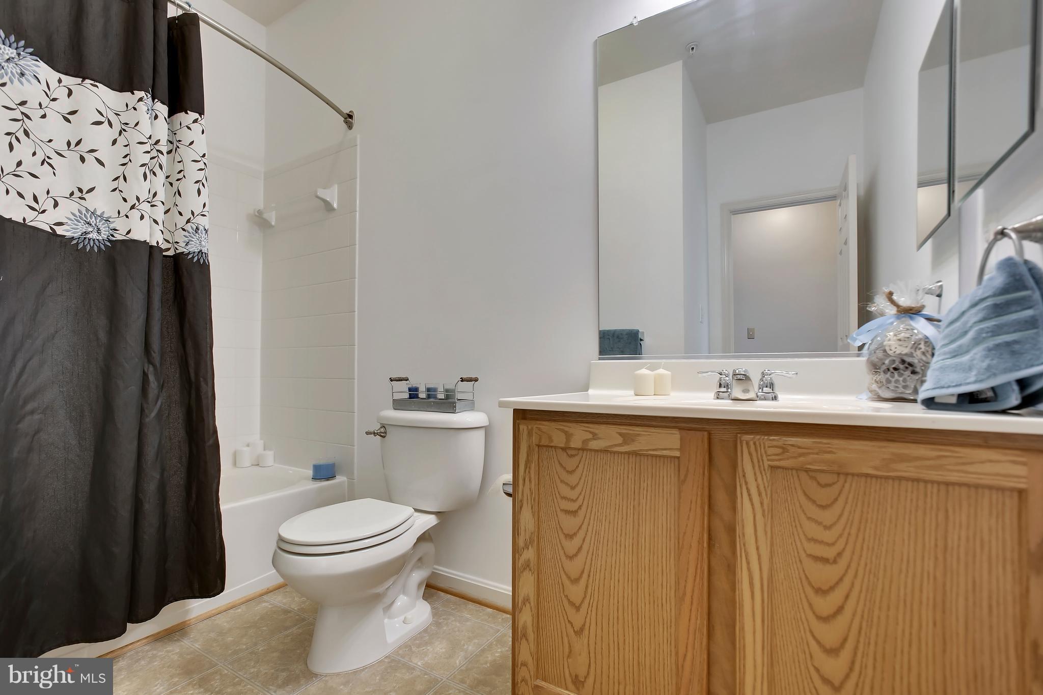 643 Tivoli Road Frederick, MD 21703 - Photo 14 of 30 a bathroom with a granite countertop sink toilet and shower