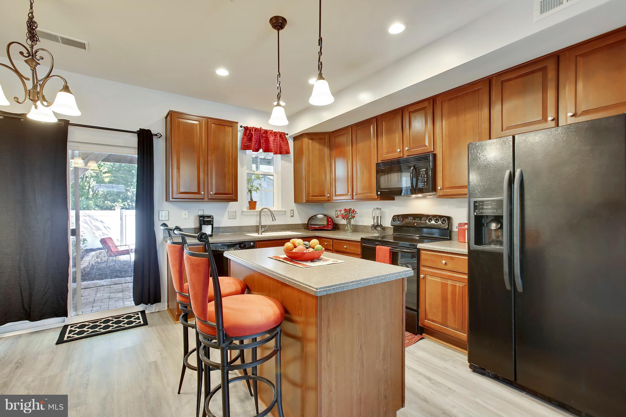 643 Tivoli Road Frederick, MD 21703 - Photo 8 of 30 a kitchen with stainless steel appliances granite countertop a sink refrigerator and a stove