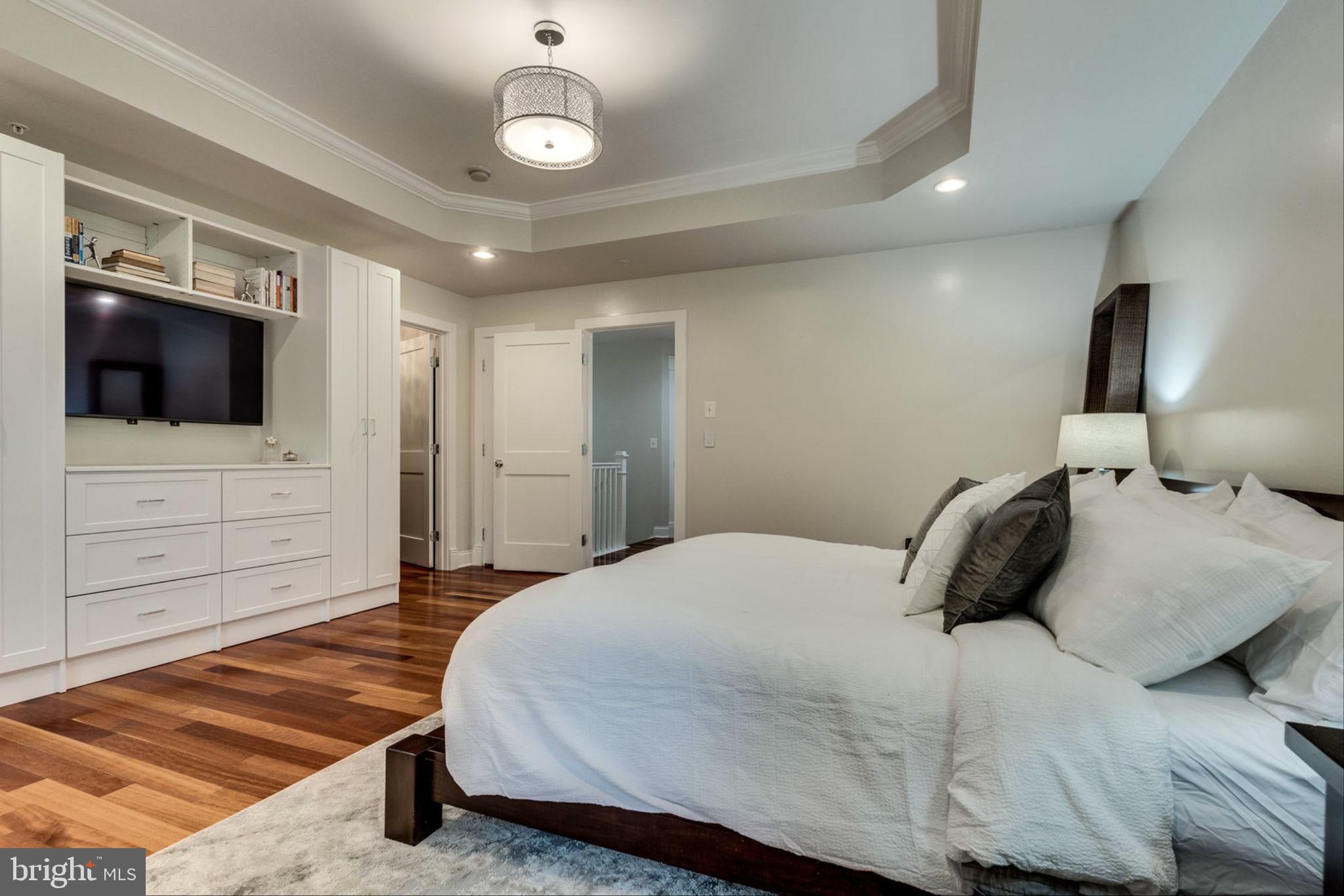 820 West Glebe Road Alexandria, VA 22305 - Photo 12 of 33 a bedroom with a bed a flat screen tv and chandelier