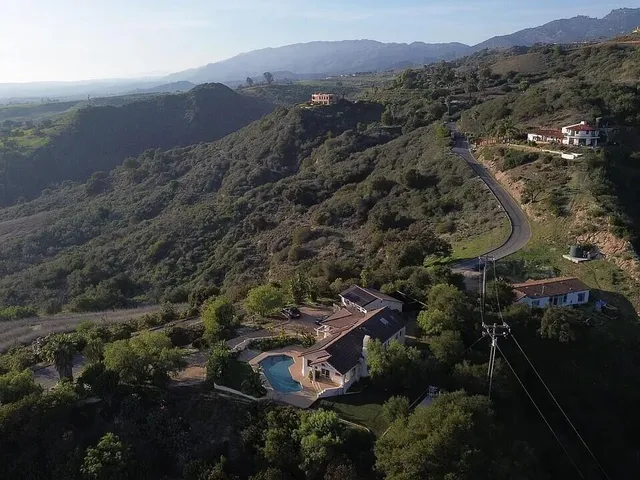 an aerial view of a house with mountain view