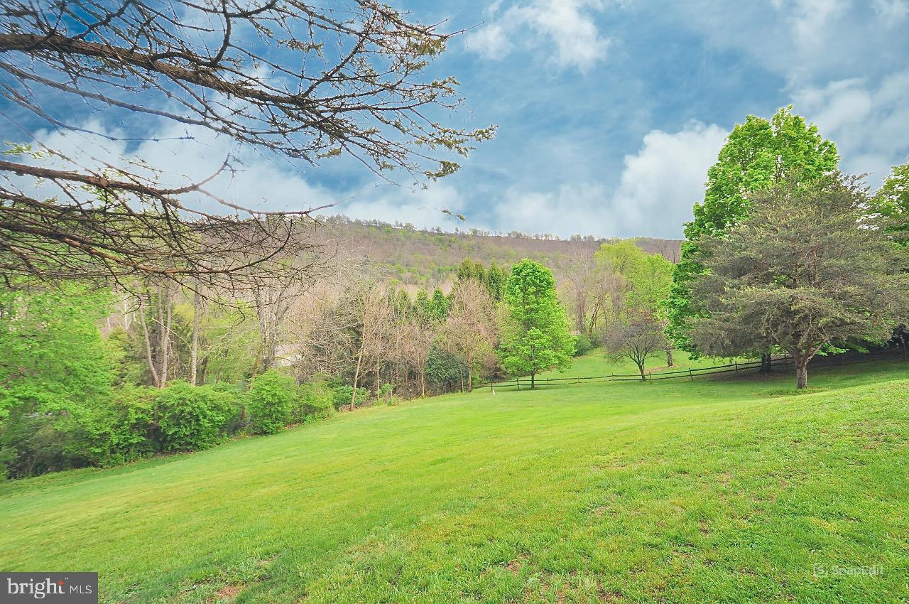9717 Frazier Crest Huntingdon, PA 16652 - Photo 25 of 27 Lush green landscape under blue skies.
