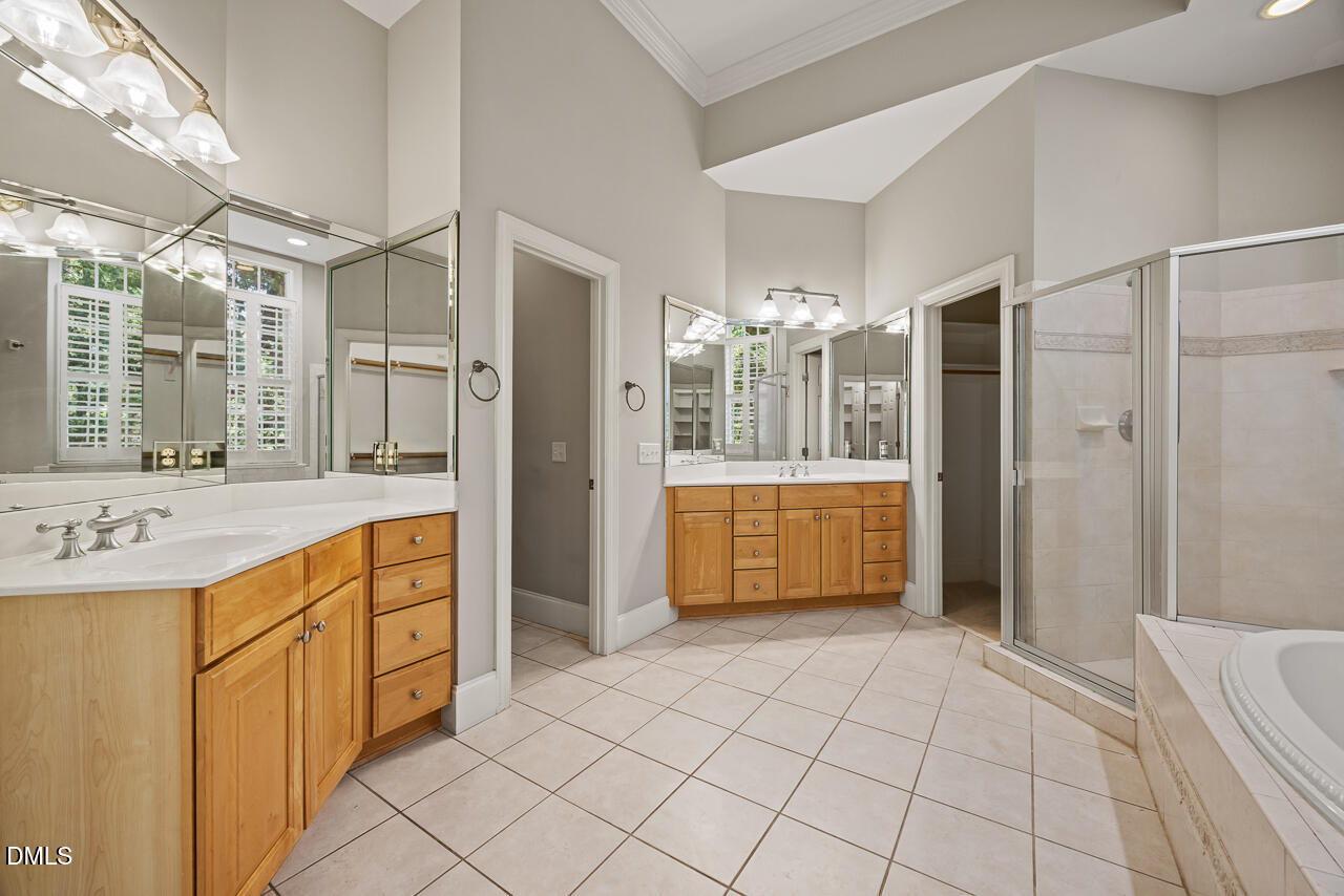 4004 Frontenac Court Apex, NC 27539 - Photo 28 of 61 a spacious bathroom with a sink a mirror and a shower