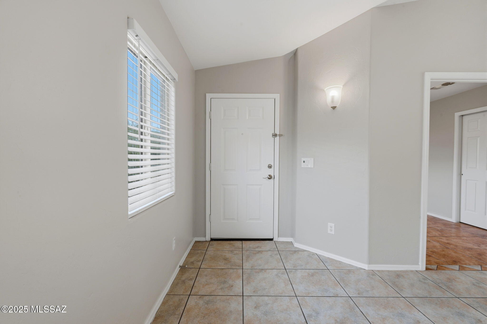 8244 South Lost Mountain Road Tucson, AZ 85747 - Photo 3 of 41 a view of an empty room with window and closet area
