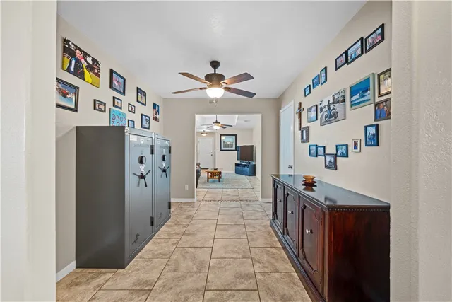 a hallway with a dining table a stove and a book shelf