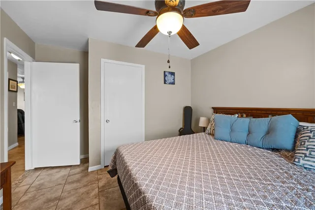 a bedroom with a bed and ceiling fan
