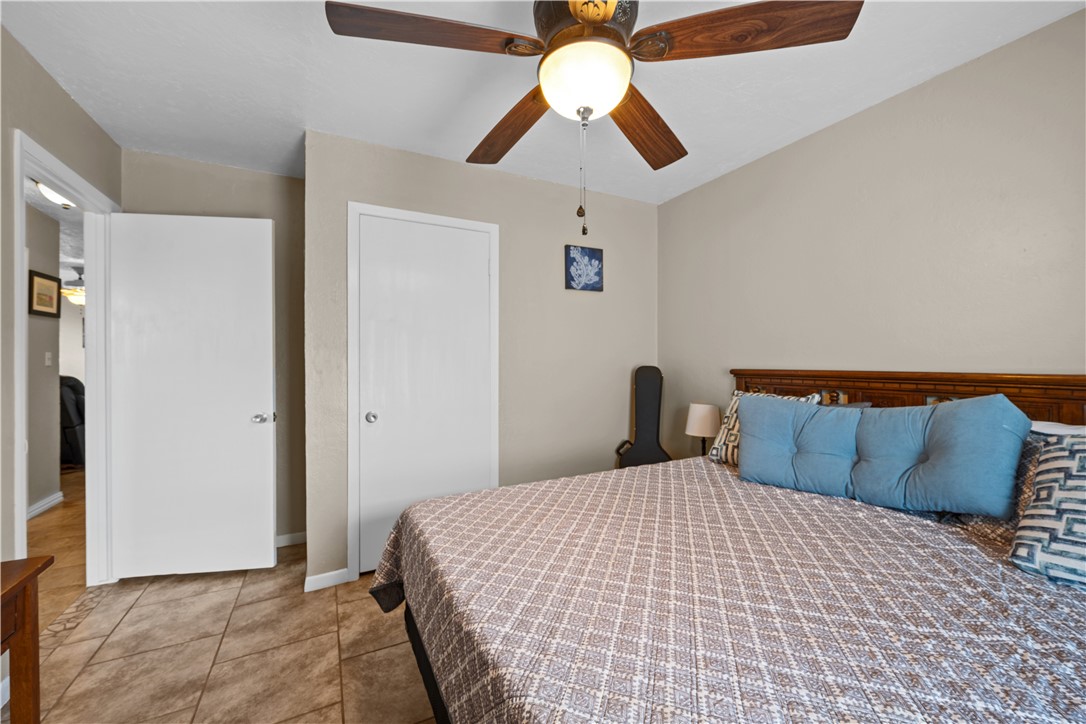 464 Sunset Ingleside, TX 78362 - Photo 22 of 35 a bedroom with a bed and ceiling fan