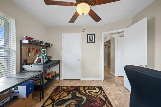 a view of a hallway with workspace and mirror