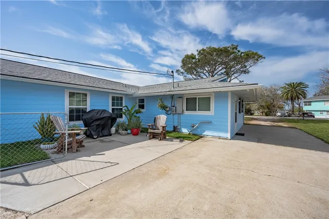 a view of a patio with table and chairs and potted plants