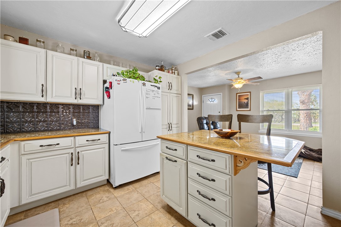 464 Sunset Ingleside, TX 78362 - Photo 5 of 35 a kitchen with white cabinets and white appliances