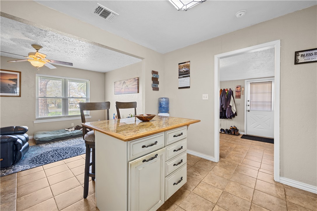 464 Sunset Ingleside, TX 78362 - Photo 6 of 35 a kitchen with a stove a sink and a refrigerator