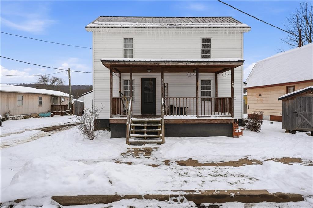 a view of a house with a yard covered in snow