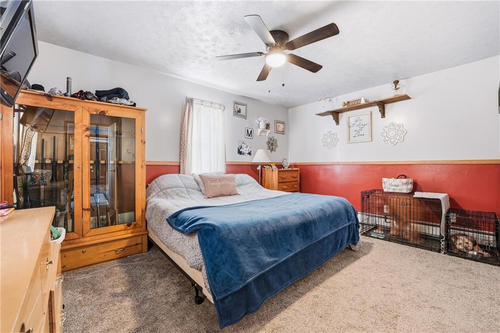 117 Erie Street Polk, PA 16342 - Photo 14 of 35 a bedroom with a bed and a chandelier