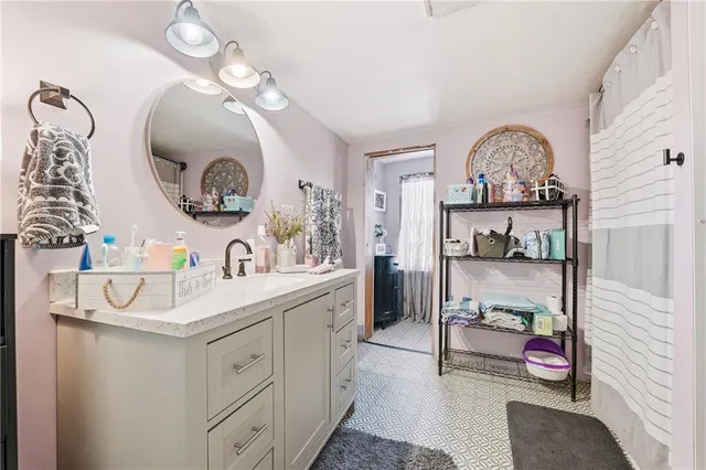 a bathroom with a sink mirror and vanity