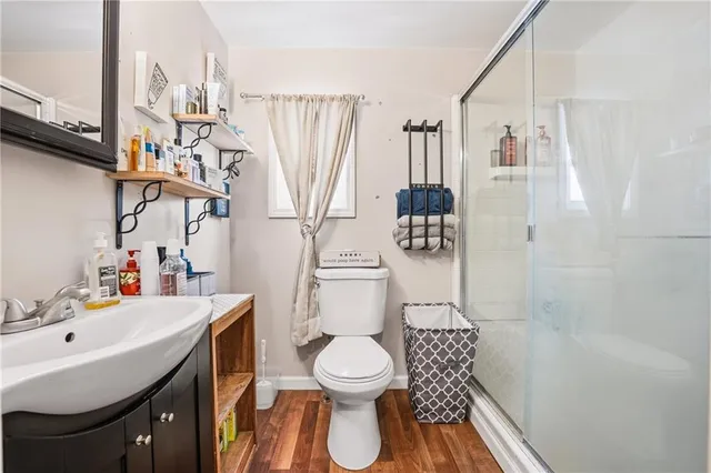 a bathroom with a toilet sink and mirror