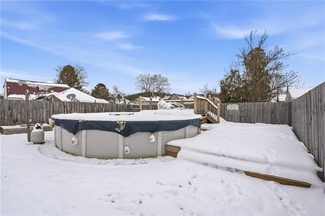 a view of a house with backyard and parking