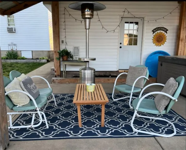 a view of a chairs and table in backyard