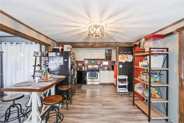 a view of a dining room with furniture and wooden floor