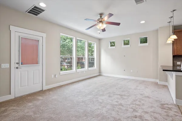 an open kitchen with kitchen island white cabinets and refrigerator