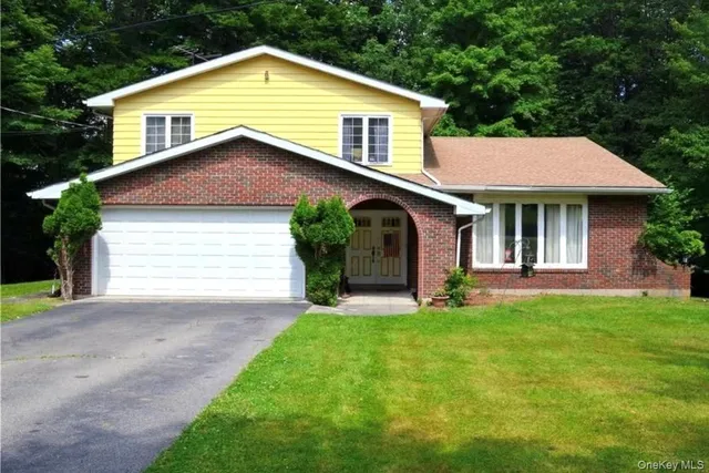 a front view of a house with a garden and plants