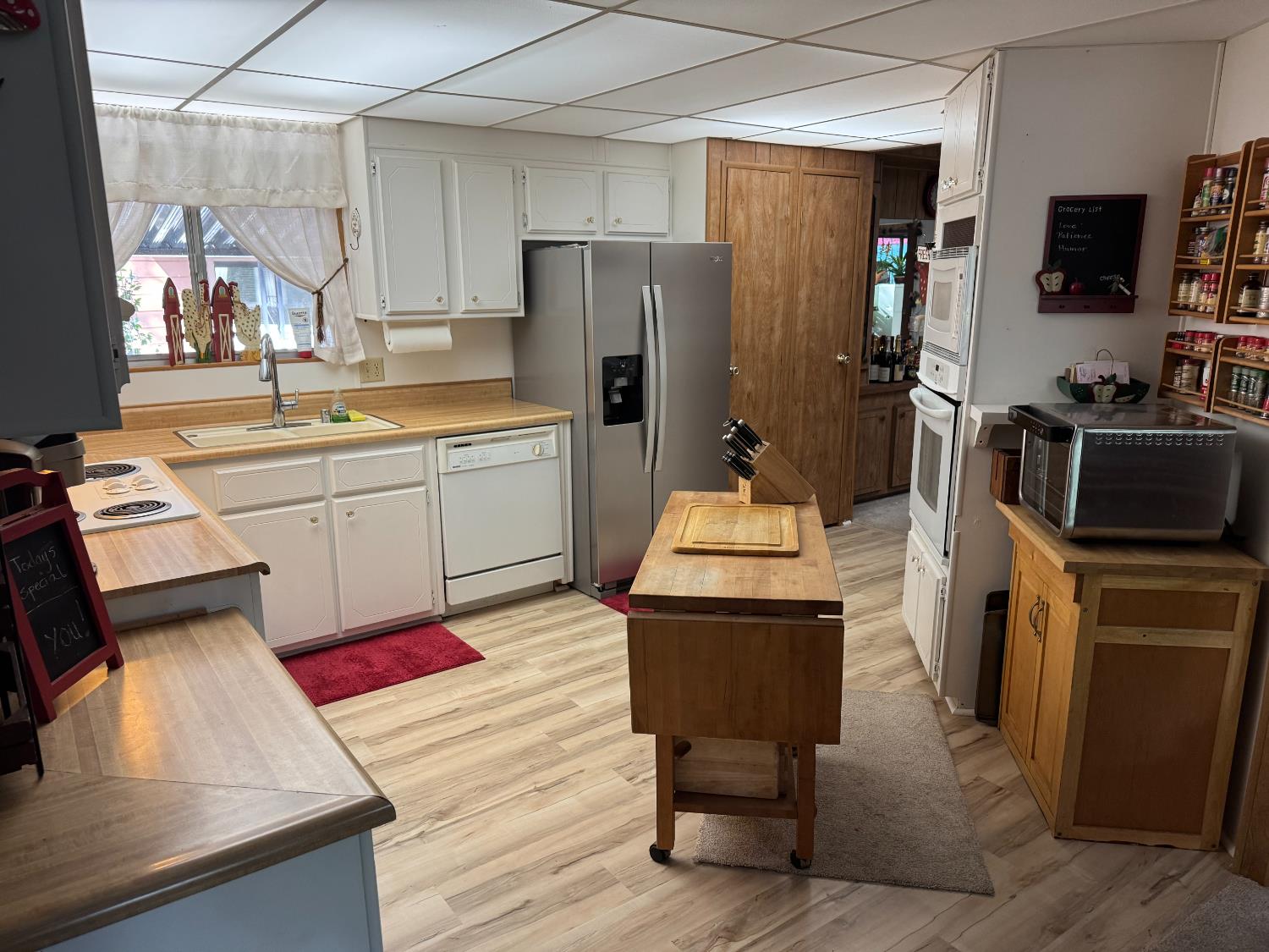 4420 Pleasant Valley Road, Unit 130 Diamond Springs, CA 95619 - Photo 12 of 39 a kitchen with a refrigerator and a stove top oven