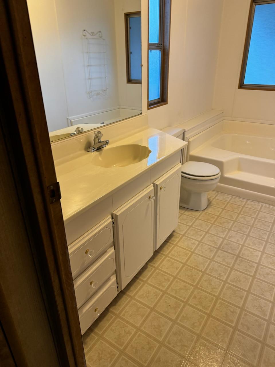 4420 Pleasant Valley Road, Unit 130 Diamond Springs, CA 95619 - Photo 27 of 39 a bathroom with a sink a toilet and a mirror