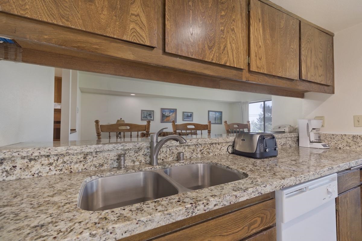25 Lee Road, Unit 111 Mammoth Lakes, CA 93546 - Photo 16 of 32 a kitchen with granite countertop a sink and cabinets