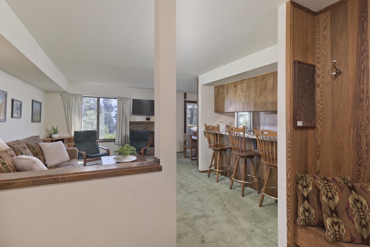 25 Lee Road, Unit 111 Mammoth Lakes, CA 93546 - Photo 4 of 32 a living room with furniture and a dining table