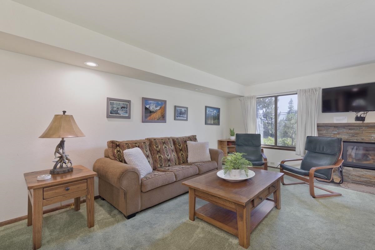 25 Lee Road, Unit 111 Mammoth Lakes, CA 93546 - Photo 5 of 32 a living room with furniture a flat screen tv and a window
