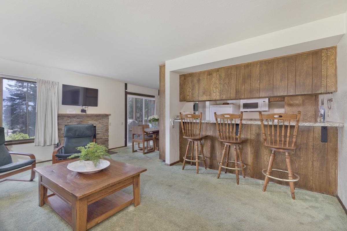 25 Lee Road, Unit 111 Mammoth Lakes, CA 93546 - Photo 6 of 32 a living room with furniture a fireplace and a flat screen tv