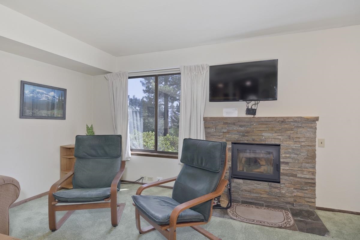 25 Lee Road, Unit 111 Mammoth Lakes, CA 93546 - Photo 8 of 32 a living room with furniture and a fireplace