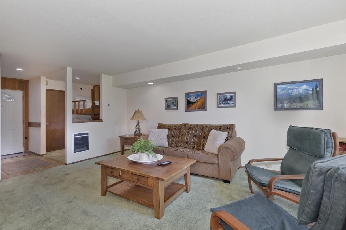 25 Lee Road, Unit 111 Mammoth Lakes, CA 93546 - Photo 9 of 32 a living room with furniture and a table