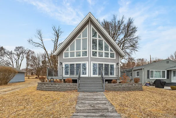 a front view of a house with a yard covered in snow