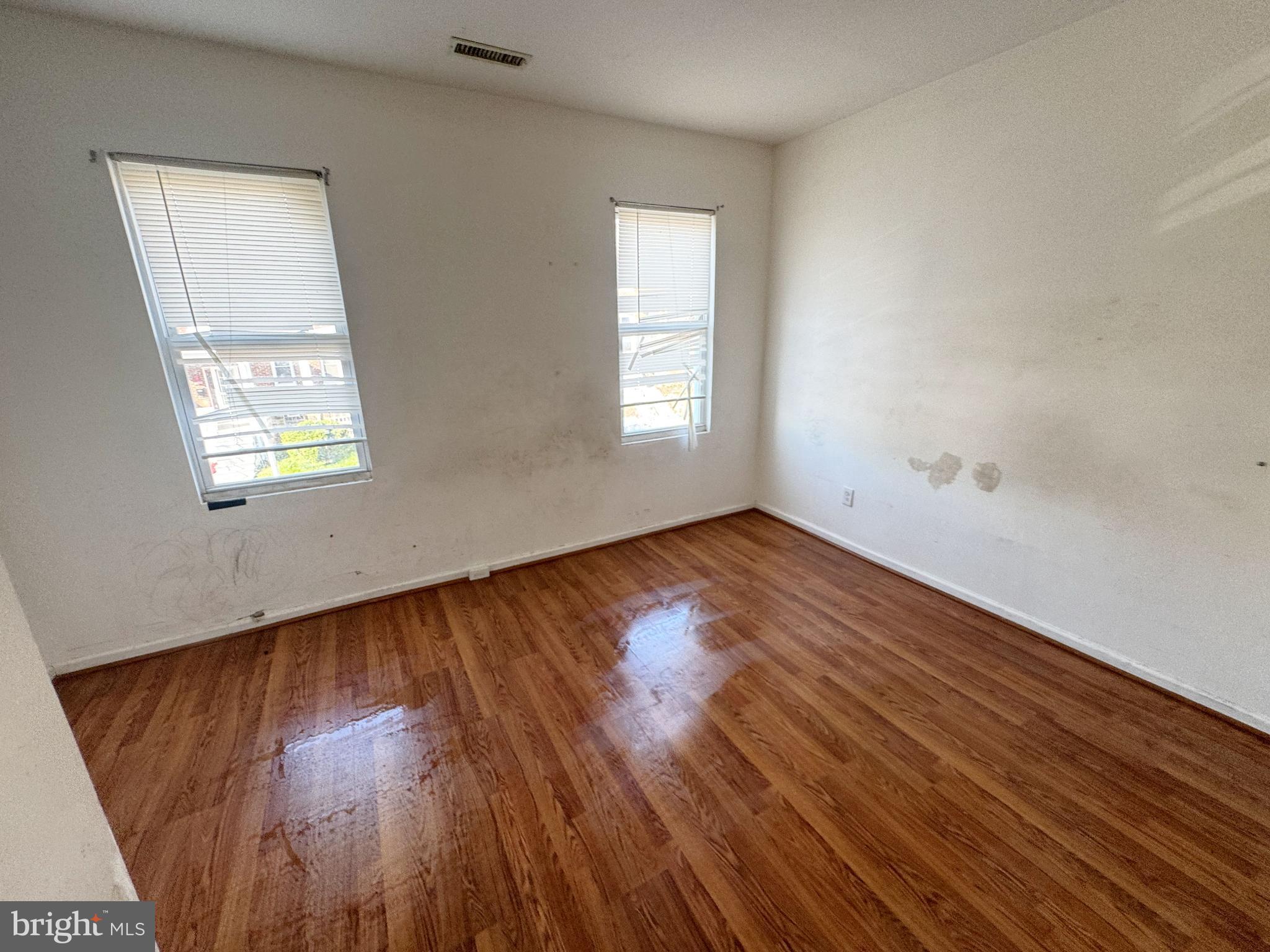 3012 Kentucky Avenue Baltimore, MD 21213 - Photo 11 of 20 an empty room with wooden floor and windows
