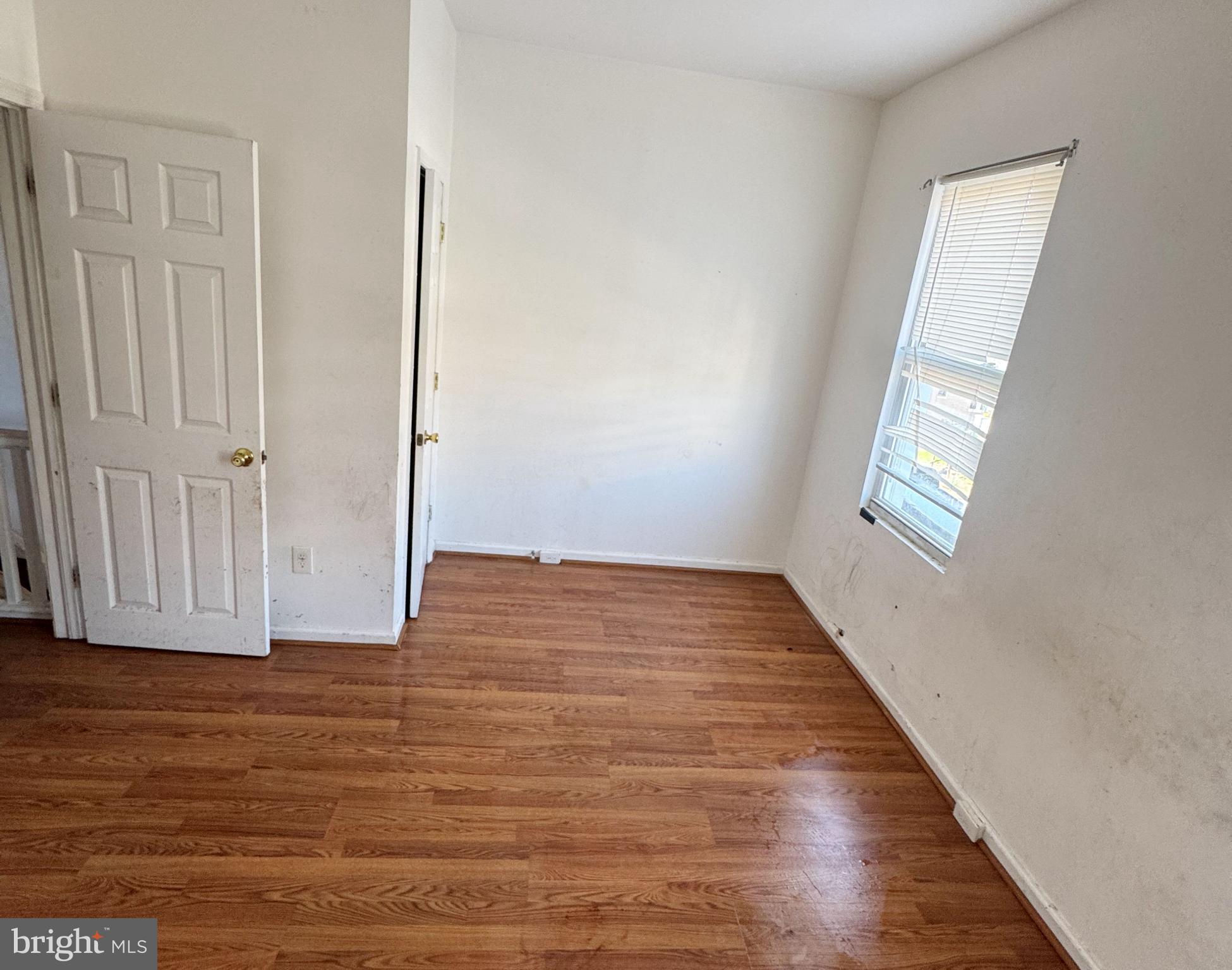 3012 Kentucky Avenue Baltimore, MD 21213 - Photo 12 of 20 an empty room with wooden floor and windows