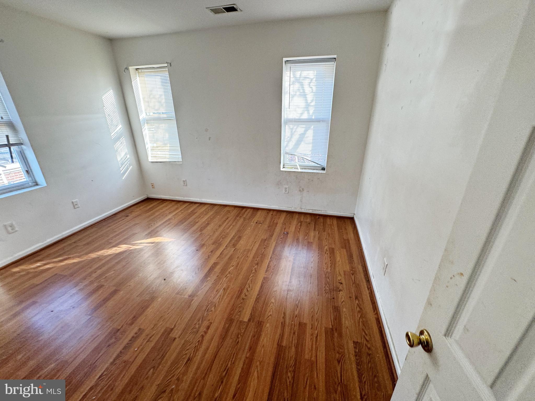 3012 Kentucky Avenue Baltimore, MD 21213 - Photo 15 of 20 an empty room with wooden floor and windows