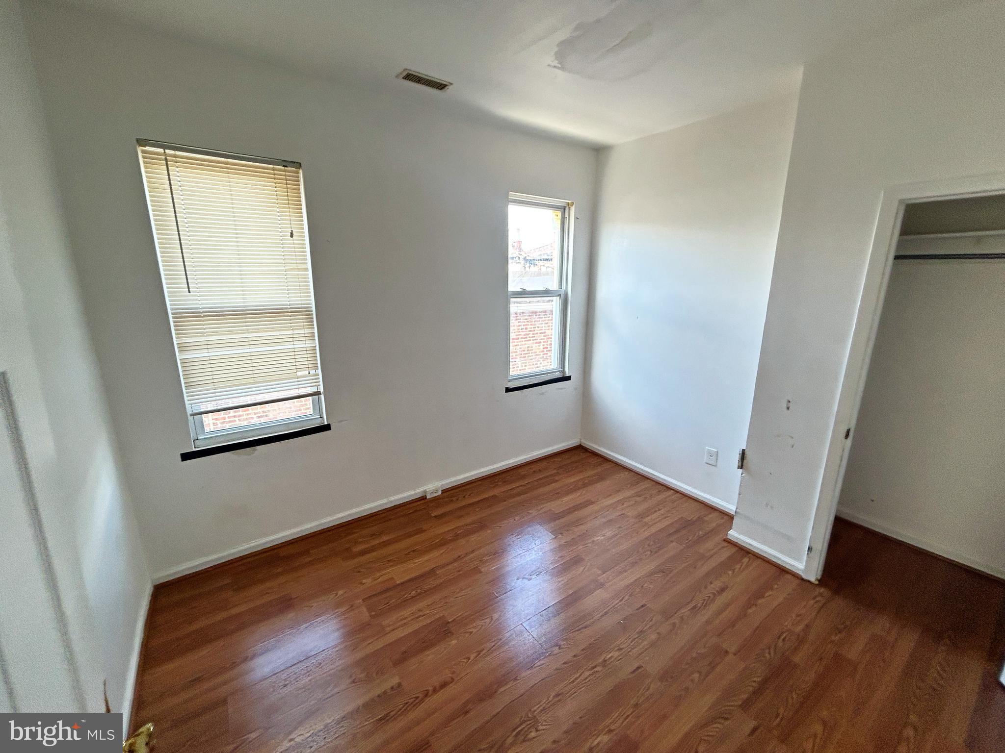 3012 Kentucky Avenue Baltimore, MD 21213 - Photo 16 of 20 a view of an empty room with wooden floor and a window