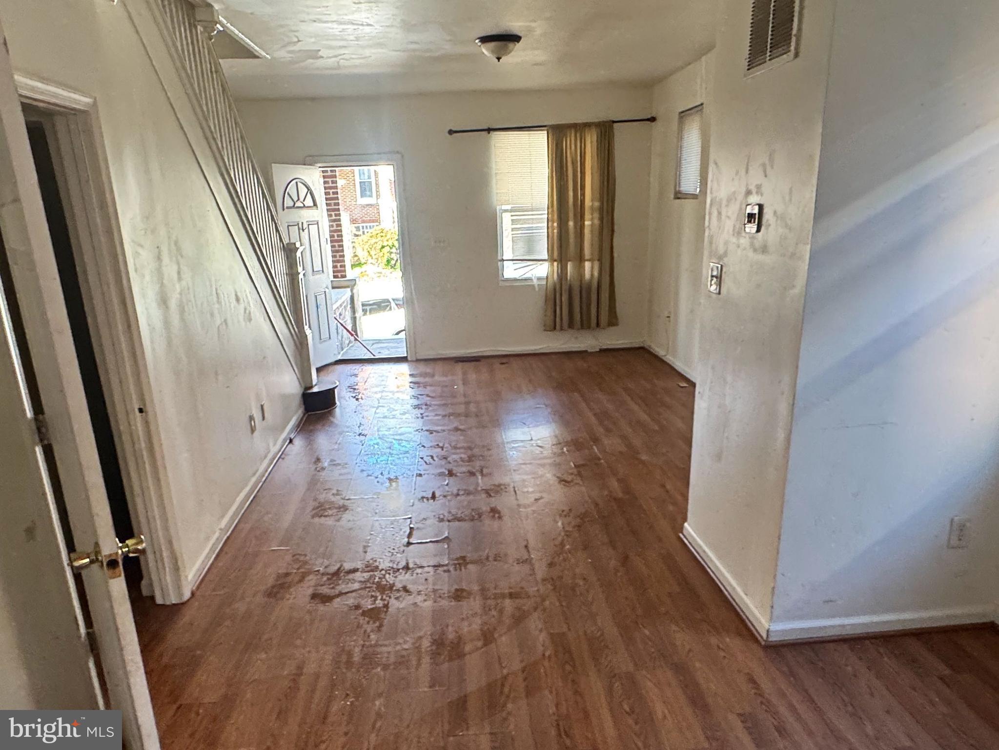 3012 Kentucky Avenue Baltimore, MD 21213 - Photo 4 of 20 wooden floor in an empty room with a window
