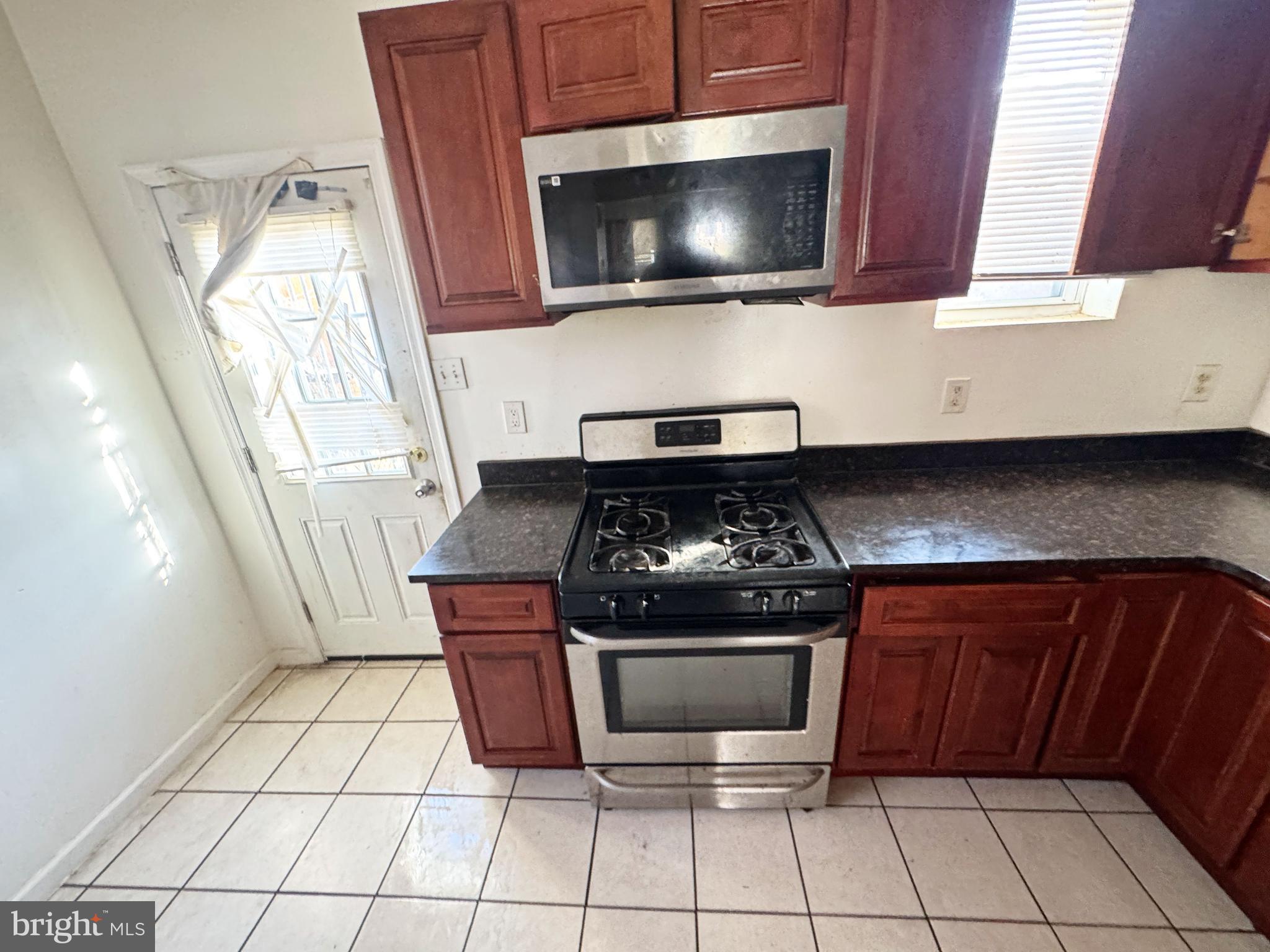 3012 Kentucky Avenue Baltimore, MD 21213 - Photo 8 of 20 a kitchen with a stove and a microwave