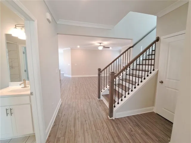 a view of entryway and hall with wooden floor