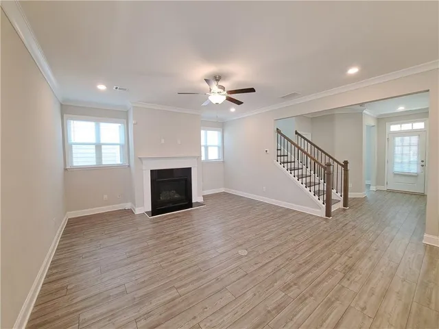 a view of a livingroom with a ceiling fan and hardwood floor