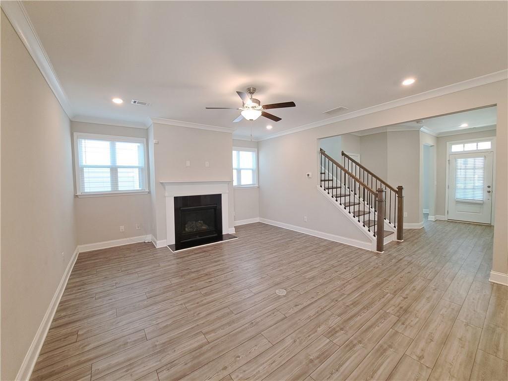 637 Stan Hope Lane Suwanee, GA 30024 - Photo 14 of 44 a view of a livingroom with a ceiling fan and hardwood floor