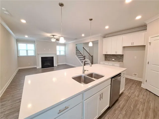 a kitchen with kitchen island a sink stainless steel appliances and a counter top