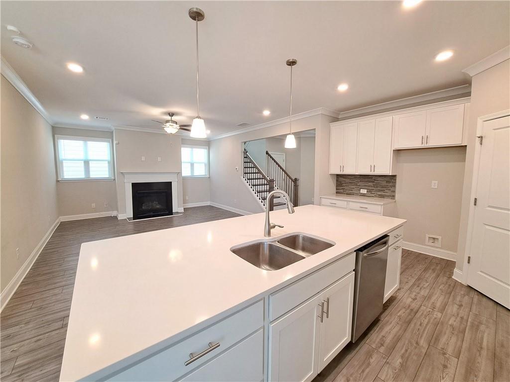 637 Stan Hope Lane Suwanee, GA 30024 - Photo 17 of 44 a kitchen with kitchen island a sink stainless steel appliances and a counter top
