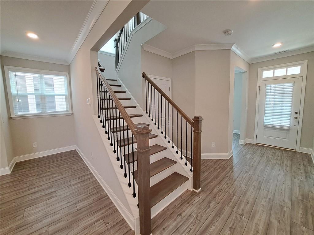 637 Stan Hope Lane Suwanee, GA 30024 - Photo 21 of 44 a view of an entryway with wooden floor and stairs