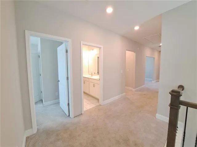an empty room with windows and chandelier fan