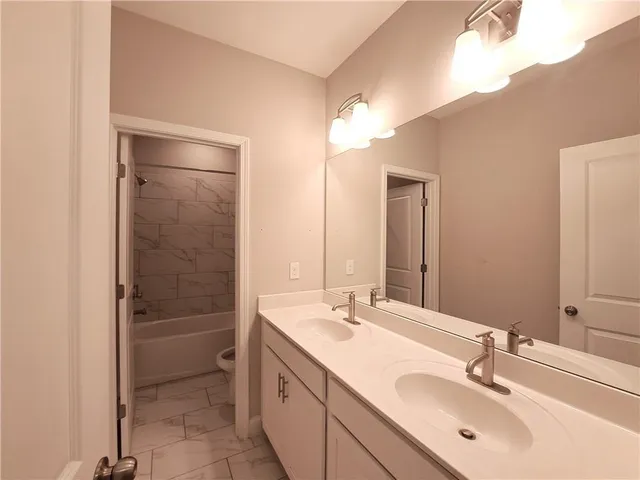 a bathroom with a double vanity sink mirror and double